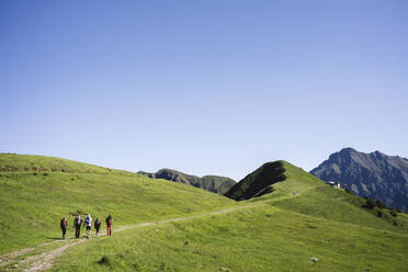 Group of hikers walking in the mountains, Orobie Mountains, Lecco, Italy - MCVF00003