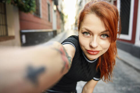 Selfie portrait of red-haired woman in the city - JSMF01265