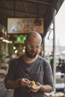 Man eating tofu - JOHF00045