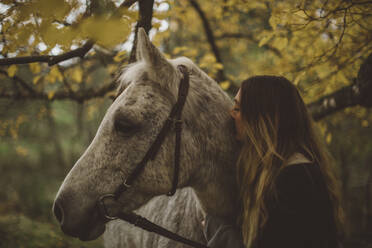 Woman with horse in forest - JOHF00047