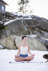 Junge Frau macht Yoga im Schnee - JOHF00088