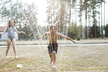 Cheerful kids playing with water - JOHF00098