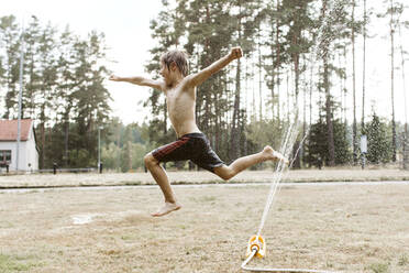 Cheerful boy playing with water - JOHF00100