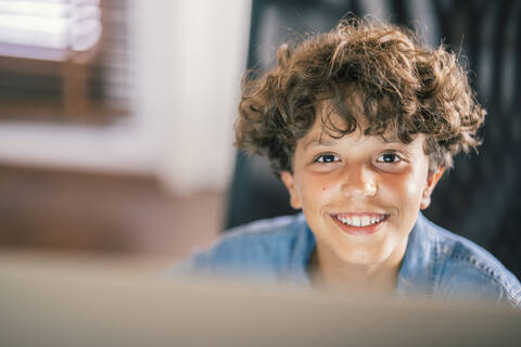 Portrait of smiling boy at home stock photo