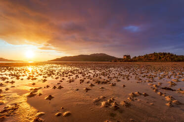 Blick auf Loch Moidart mit Castle Tioram im Hintergrund gegen den bewölkten Himmel bei Sonnenuntergang, Ardnamurchan, Highland, Schottland, UK - SMAF01460