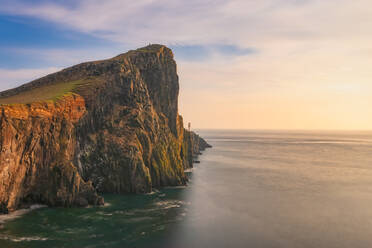 Neist Point Lighthouse by sea during sunset, Waterstein, Isle of Skye, Highlands, Scotland, UK - SMAF01490