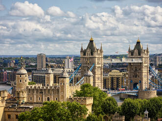 High angle view of Tower Bridge with cityscape in background against cloudy sky at London - HNF00818