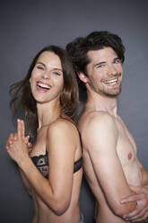 Young couple wearing underwear, full length stock photo - OFFSET