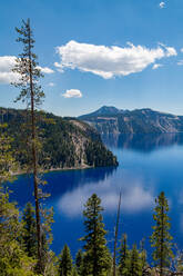 Cloud reflected in the still waters of Crater Lake, the deepest lake in the U.S.A., part of the Cascade Range, Oregon, United States of America, North America - RHPLF08691