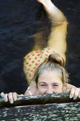 Teenage girl (16-17) swimming in sea - FOLF10331