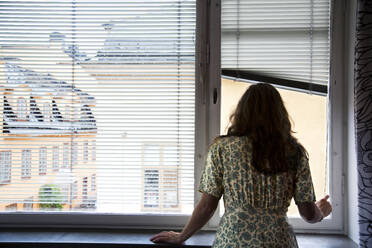 Woman looking through window - FOLF10336