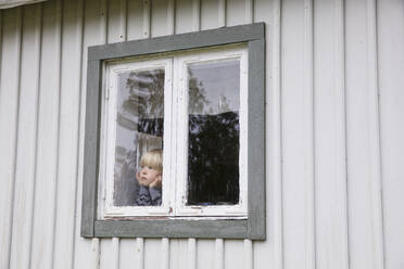 Junge im Fenster eines Hauses - FOLF10571