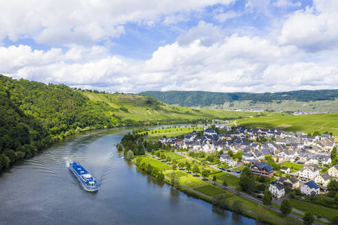 Drone shot of cruise ship on Mosel River by town against cloudy sky, Germany - RUNF02931