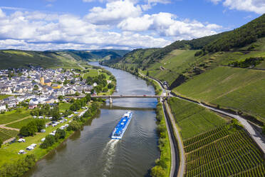 Drone shot of passenger ship on Mosel River by town against cloudy sky, Germany - RUNF02932