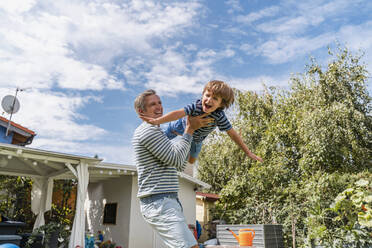 Father playing with son in garden - DIGF08174