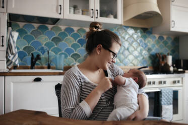 Portrait of a young woman with a baby at home - EYAF00465