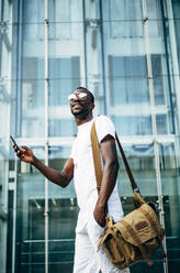 Young man with mobile phone in the city - OCMF00682