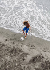 Boy playing football on the beach - LJF00977