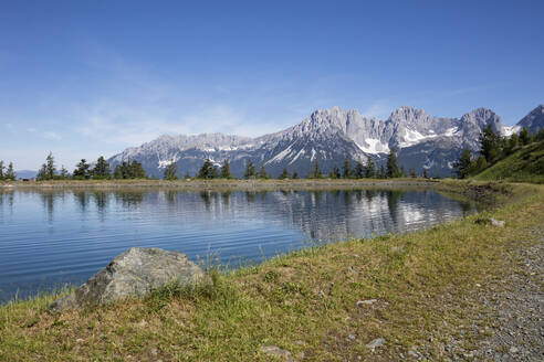 Astbergsee lake with Kaiser Mountains against sky at Astberg, Kitzbühel, Tyrol, Austria - WIF04034