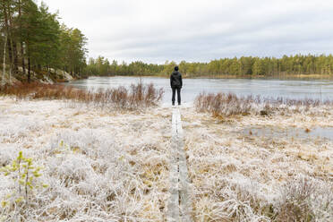 Mature woman standing in front of Lake Lillskiren in Sweden - FOLF10826