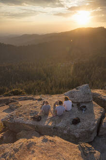 Männer auf einem Felsen bei Sonnenuntergang im Sequoia National Park in Kalifornien - FOLF10870