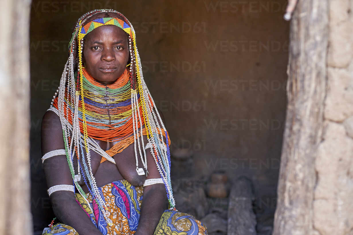 Portrait of a Muhila traditional woman sitting in her house