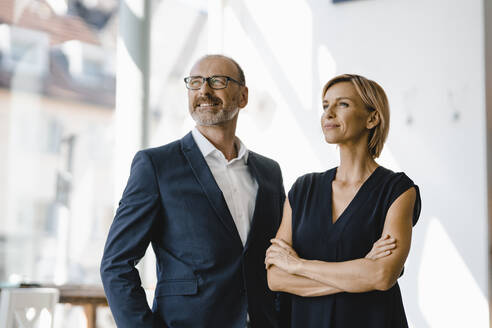 Portrait of confident businessman and woman - KNSF06347