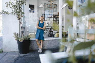 young business owner, standing in front of her coffee shop - KNSF06400