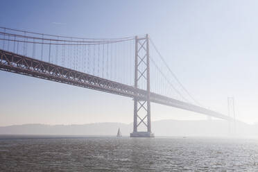 April 25th Bridge over Tagus river against sky, Lisbon, Portugal - XCF00196