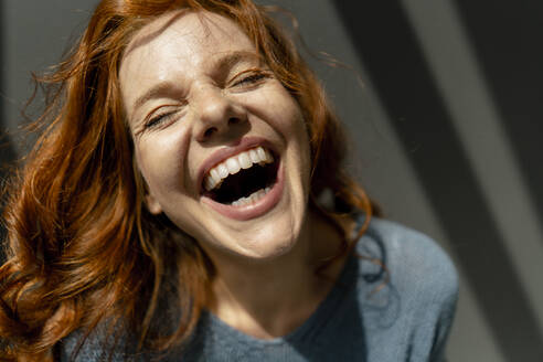 Portrait of laughing redheaded woman - KNSF06458
