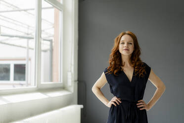 Portrait of redheaded businesswoman in a loft - KNSF06482