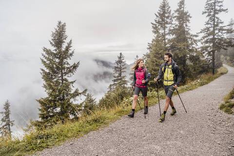 Young couple on a hiking trip in the mountains, Herzogstand, Bavaria, Germany stock photo