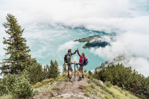 Glückliches junges Paar bei einer Wanderung in den Bergen, Herzogstand, Bayern, Deutschland, lizenzfreies Stockfoto