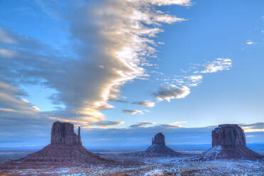 Sunrise, West Mitten Butte on left, East Mitten Butte in centre and Merrick Butte on right, Monument Valley Navajo Tribal Park, Utah, United States of America, North America - RHPLF08774