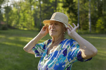 Ältere Frau mit Sonnenhut im Feld - FOLF11010