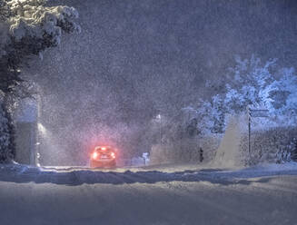 Tail lights of car on snowy road at night - FOLF11016