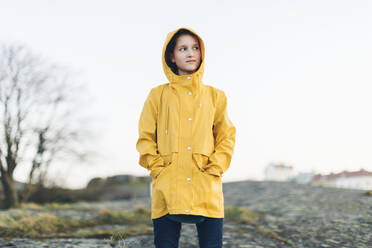 Girl wearing yellow coat in park - FOLF11076