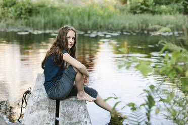 Girl sitting on jetty - FOLF11166