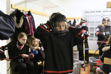 Mädchen in der Umkleidekabine bereiten sich auf das Eishockeytraining vor - FOLF11184