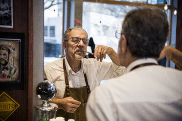 Barber trimming his moustache - FOLF11261