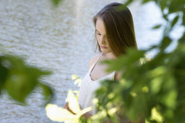 Young woman behind branches - FOLF11309