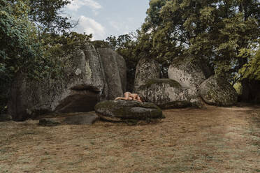 Nude woman lying on a rock at Beglik Tash prehistoric rock sanctuary, Bulgaria - AFVF03899