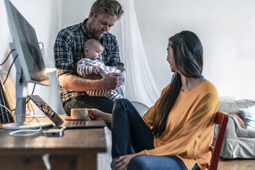 Young woman with her family in home office - RIBF00998