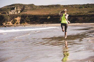 Female jogger at the beach - UUF19002