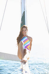 Portrait confident woman in bathing suit on sunny sailboat - FSIF04413