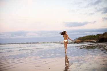 Carefree woman in bikini running on beach, Sayulita, Nayarit, Mexico - FSIF04418