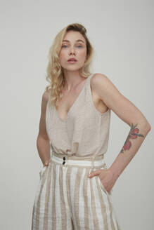Portrait of blond tattooed woman wearing summer fashion - PGCF00003