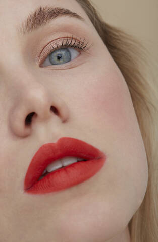 Woman's face with made up red lips, close-up stock photo