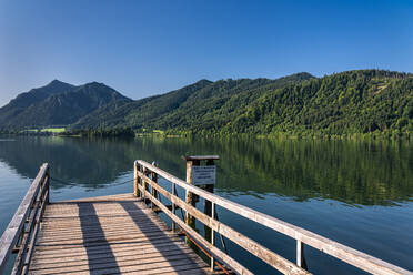 Footbridge at Schliersee lake against clear blue sky, Mangfallgebirge, Germany - STSF02253