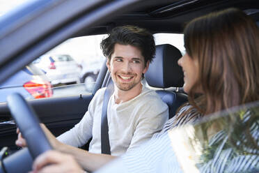 Happy couple in a car with woman driving - PNEF01980